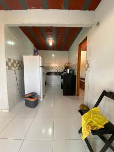 a kitchen with a white floor and a refrigerator at Casa na Serra de Pacoti in Pacoti