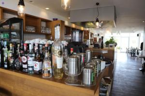 a bar with bottles of alcohol on a counter at Ferienwohnung FAIRWAY in Hohenkirchen