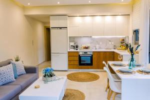eine Küche und ein Wohnzimmer mit Sofa und Tisch in der Unterkunft Villa Eutuxia in Antikyra