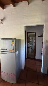 a kitchen with a refrigerator in a room at Casa cercana a plaza de Villa de las Rosas con patio y asador in Villa de Las Rosas