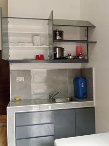 a kitchen with a sink and a counter top at BMR Apartment in Dipolog