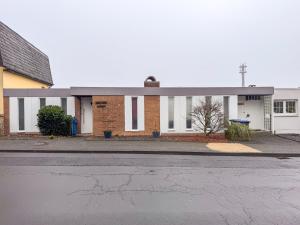 an empty street in front of a brick building at TRIMOSA - Apartments & Homes in Bitburg