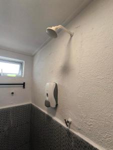 a bathroom with a roll of toilet paper on the wall at Seahorse Diver Guesthouse in Perhentian Islands +33 photos
