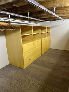 an empty room with wooden cabinets and shelves at Suite Burotti - Cherasco in Cherasco