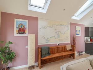 a room with a bench and a map on the wall at The Lodge at Redlands in Lyme Regis