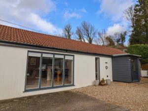 a detached house with a large sliding glass door at The Lodge at Redlands in Lyme Regis