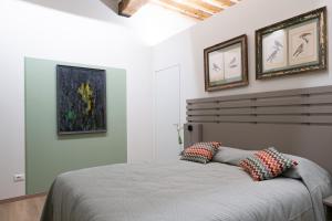 a bedroom with a bed with two pillows on it at Borgo35 in Parma +51 photos