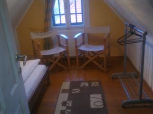 a room with a staircase with chairs and a rug on the floor at Casa Gabriela in Sinaia