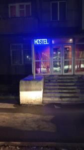 a hotel sign in front of a building at night at Хостел in Almaty +21 photos