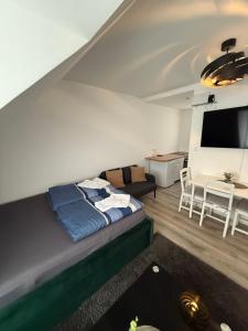 a bedroom with a bed and a living room at Ferienwohnung Centro 2 in Bremerhaven