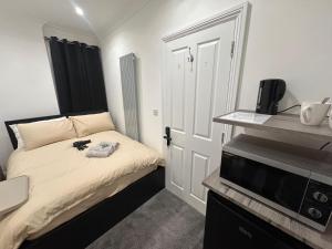 a small bedroom with a bed and a television at London Bridge Room in London