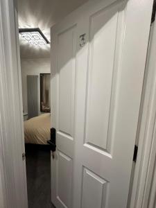 a door leading to a bedroom with a bed at London Bridge Room in London