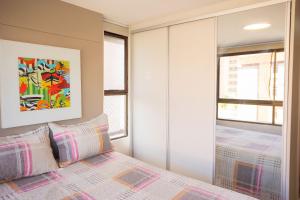 a bedroom with a bed and two windows at Paraíso do Atlântico #102D - Estilo por Carpediem in Ilha da Restinga +37 photos