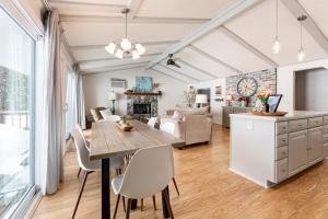a kitchen and living room with a table and chairs at Lakeshore Luxe in Williamsburg