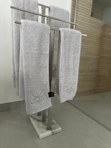 a group of towels hanging on a towel rack in a bathroom at Tiaré Appartment - FeWo in Bad Harzburg +13 photos