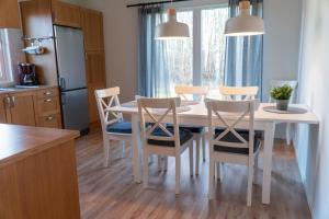 a kitchen with a white dining room table and chairs at Lägenhet - Karlskoga folkhögskola in Karlskoga