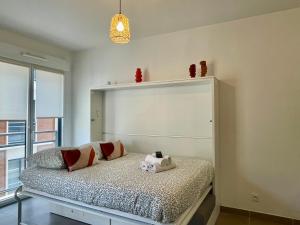 een slaapkamer met een bed en een groot raam bij Charming Studio with Parking near Monaco in Beausoleil