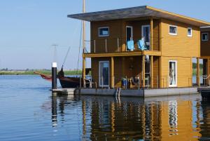 a house on a boat on the water at FLOATING HOUSES - "schwimmende Ferienhäuser" - Haus 3 in Kröslin