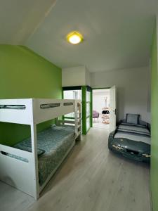 a room with two bunk beds and a bed at Idéal groupe tarif long séjour maison 4chambres 8lits 2salles de bain 3wc terrasse stationnement gratuit in Valenciennes +14 photos