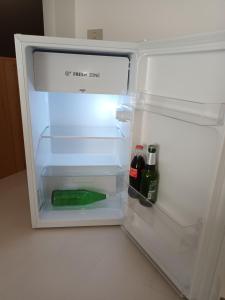 an open refrigerator with a bottle of wine in it at Joseph's house in Florence