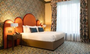 Voodi või voodid majutusasutuse The Trinity City Hotel toas
