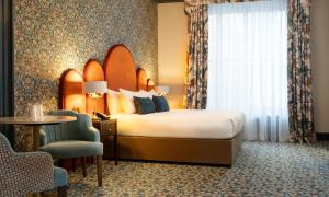 Voodi või voodid majutusasutuse The Trinity City Hotel toas