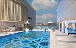 a pool on the rooftop of a hotel with a view at Andaz Dubai The Palm, By Hyatt in Dubai