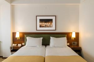 Postel nebo postele na pokoji v ubytování Hotel Sao Jose