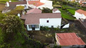an aerial view of a white house with red roofs at Blue Ocean View in São Roque do Pico
