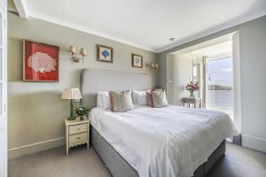 a bedroom with a large bed and a window at No 26 The Salcombe in Salcombe