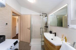 a bathroom with a sink and a shower at Sea View Apartment Betina, Murter in Betina +61 photos