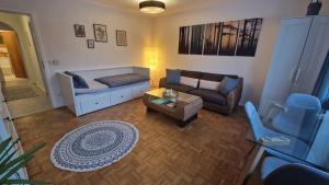 a living room with a couch and a table at Ferienwohnung Schloßberg 1 in Peiting