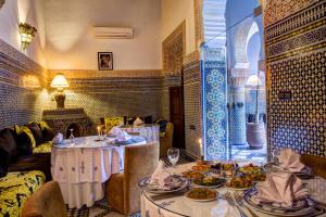 a room with two tables with plates of food at Riad Salam Fes in Fez