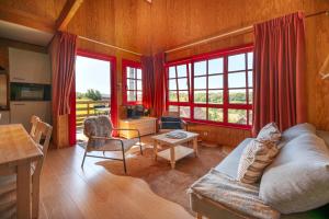 a living room with a couch and a table at Domaine Du Val in Grand-Laviers