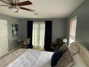 a bedroom with a bed with a ceiling fan at The Brickhouse in Gainesville