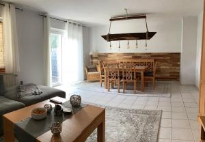 a living room with a couch and a table at Ferienhaus Höller in Grömitz