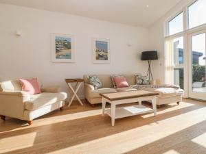 a living room with two couches and a coffee table at Una, Lodge 77 in St Ives