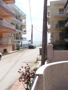 a car driving down a street next to a building at Eirini Apartment in Nea Kalikratia