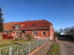 a red house with a fence in front of it at Gasthaus am Schloss in Karlsburg
