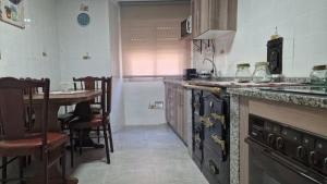 a kitchen with a counter and a table in it at Casa Engracia in Arcos