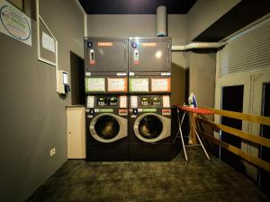 a washer and dryer in a laundry room at CATS Porto Hostel in Porto