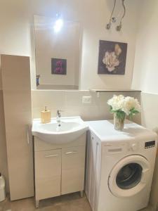 a bathroom with a washing machine and a sink at TaorminaCentre Panorama in Taormina