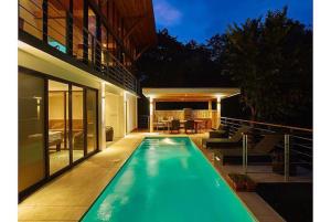 a swimming pool in the backyard of a house at Casa Canopy in Nosara
