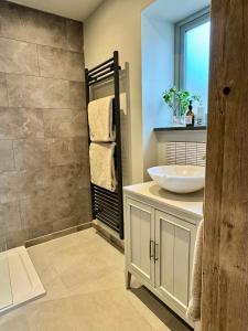 a bathroom with a sink and a mirror at Mowhay Barn in Bodmin