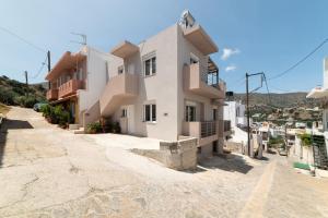 a house on the side of a street at G Berdufi 2 bd with parking in Eloúnda in Elounda