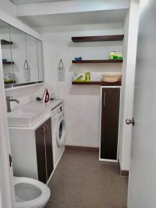 a small bathroom with a sink and a washing machine at Avida Riala Tower 2, IT Park, New Fully Furnished in Cebu City