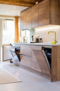 a kitchen with wooden cabinets and a sink at Mowhay Barn in Bodmin +10 photos