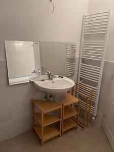a bathroom with a sink and a mirror at Glam One Bedroom Duplex in Vila in city centre in Arad +16 photos