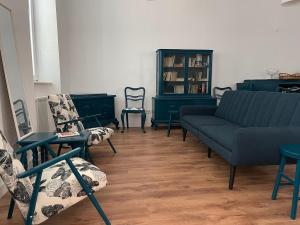 a living room with chairs and a couch and chairs at Glam One Bedroom Duplex in Vila in city centre in Arad