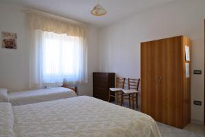 Posteľ alebo postele v izbe v ubytovaní L Agrifoglio di Rita Loddo